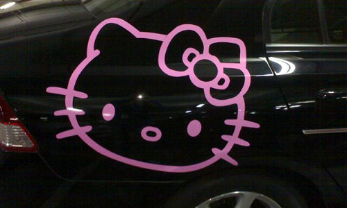  black Honda civic car adorned with a bright pink Hello Kitty car decal